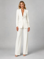 Woman wearing a white tailored blazer and wide-leg trouser set, front view