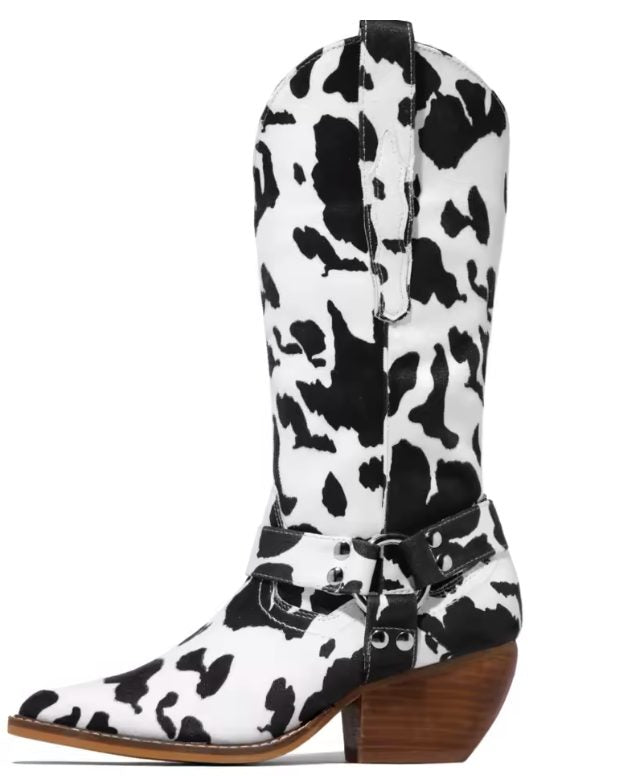 Close-up detail of cow-print cowboy boot