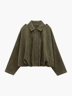 Woman wearing a faux suede collared bomber jacket, front view