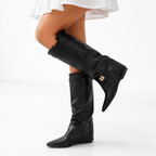 Sleek black knee-high vegan leather boots with elegant pointed toe