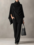 Woman wearing a knitted cowl-neck co-ord set with wide-leg trousers, front view