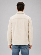 Men's corduroy overshirt jacket, side view showing relaxed fit on model