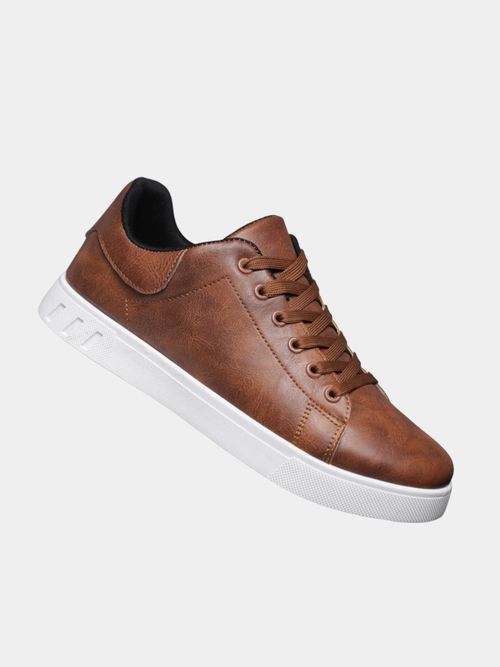 Man wearing men's leather lace-up sneakers