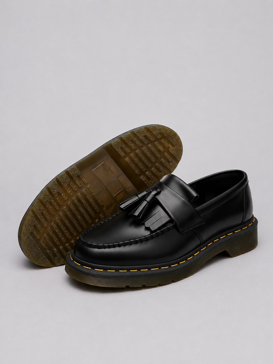 Men's black tassel loafer showing textured sole