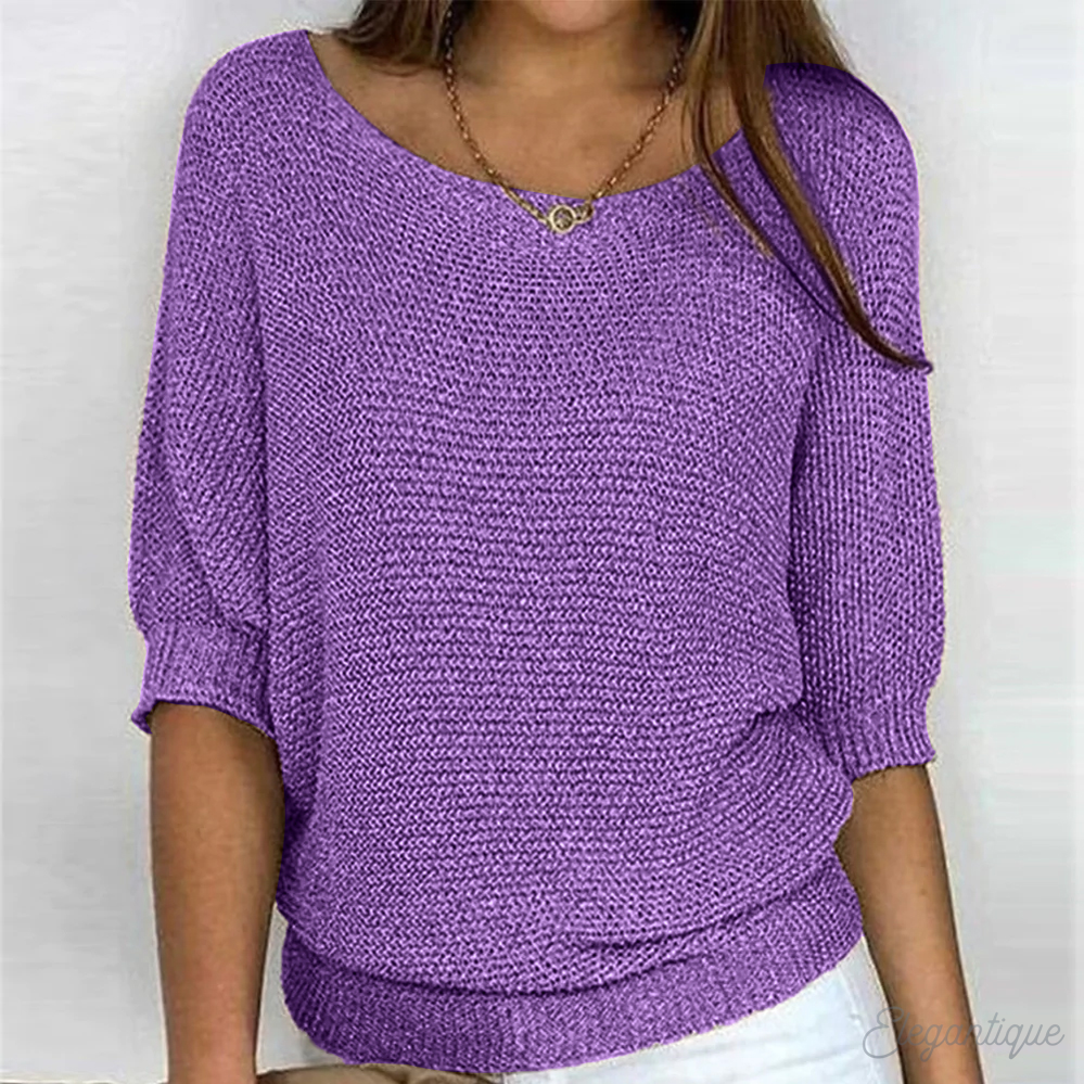 Relaxed round-neck knit sweater with ribbed hem shown on a model