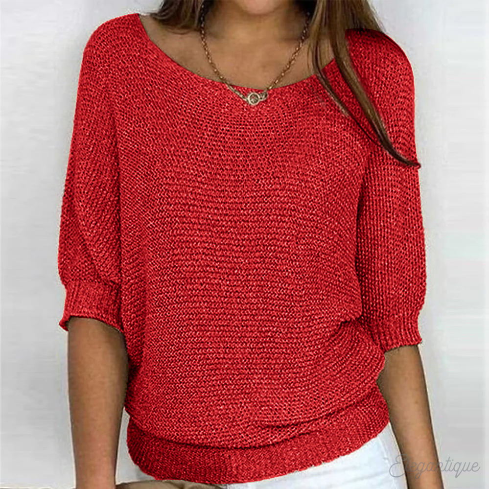 Side view of a relaxed round-neck knit sweater with wide sleeves