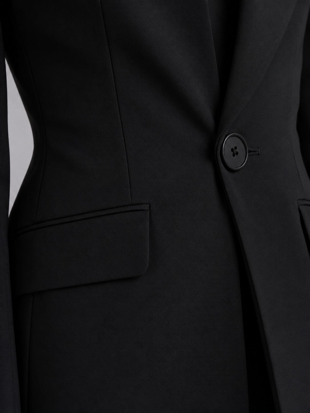 Black single-breasted blazer and flared trouser set, detail view