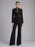 Woman wearing a black single-breasted blazer and flared trouser set