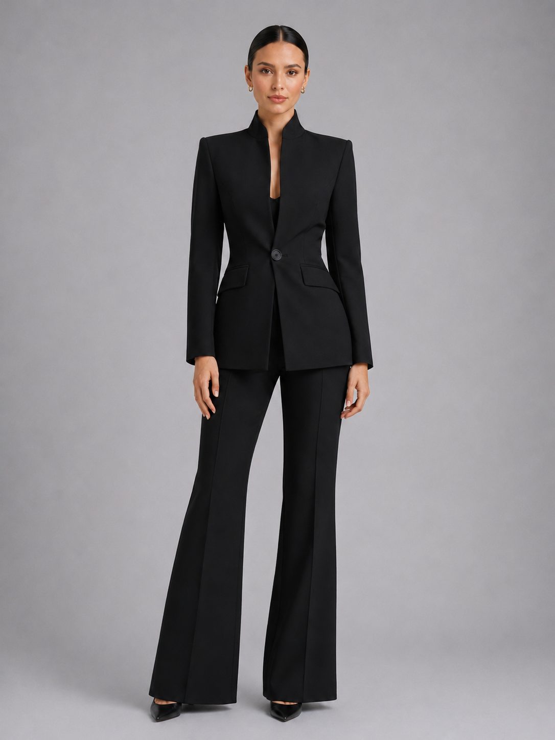 Woman wearing a black single-breasted blazer and flared trouser set