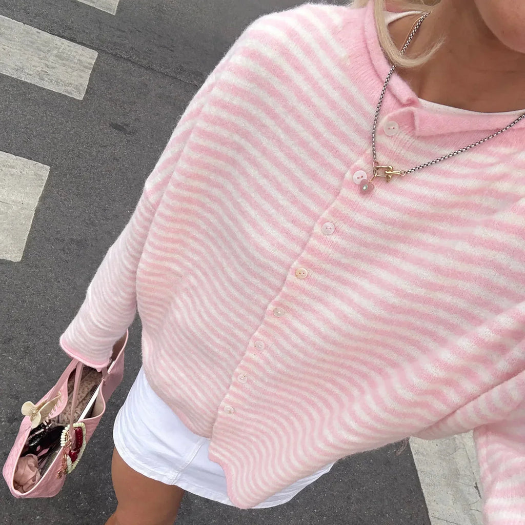 Model wearing an oversized striped knit cardigan with long sleeves