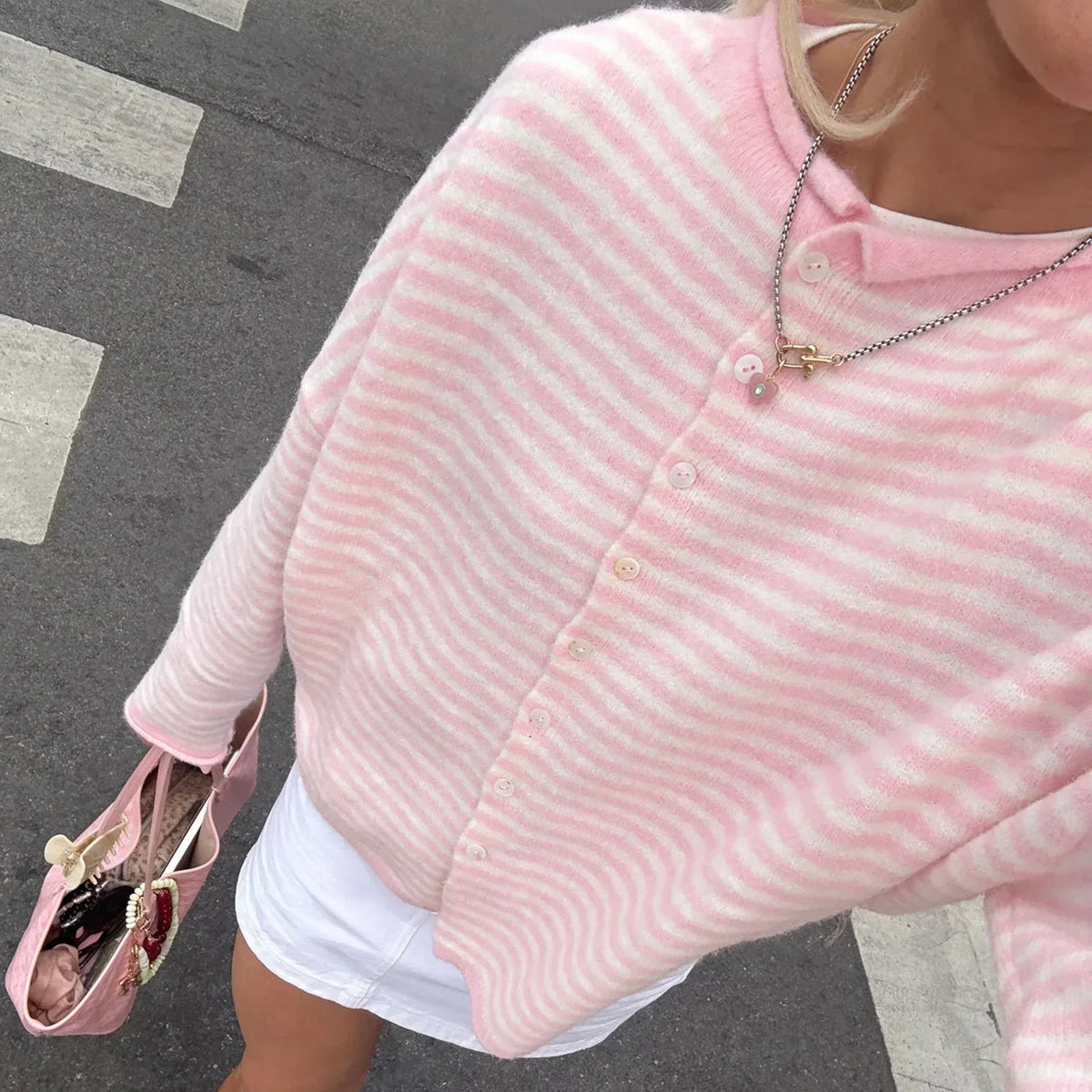 Model wearing an oversized striped knit cardigan with long sleeves
