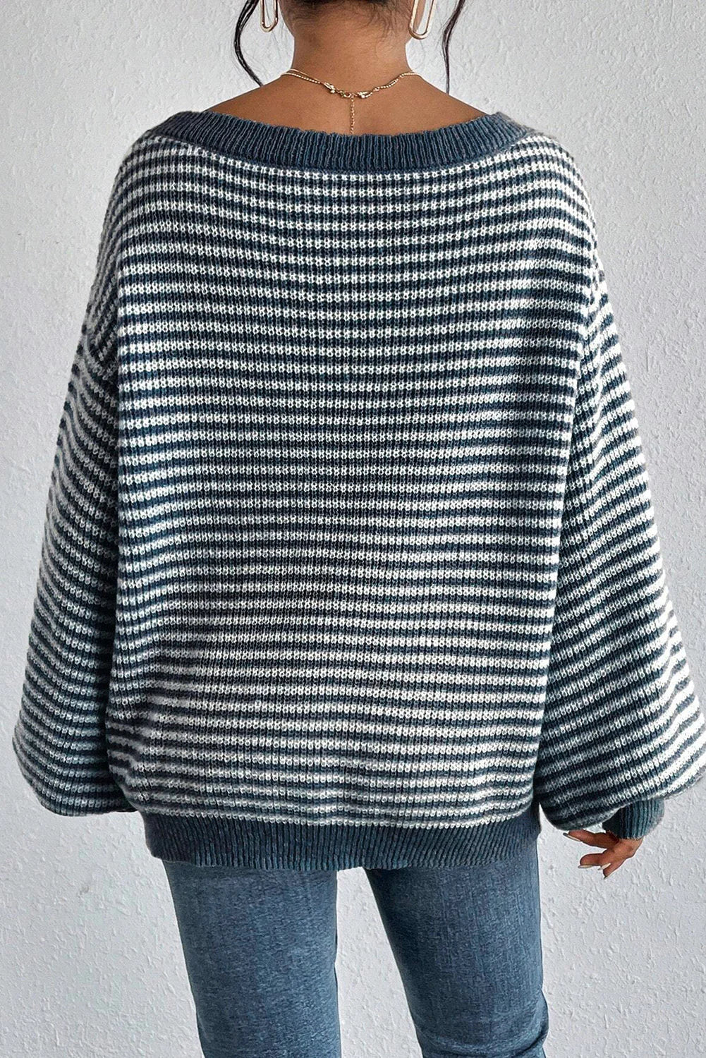 Close-up of the off-shoulder neckline on a striped knit sweater