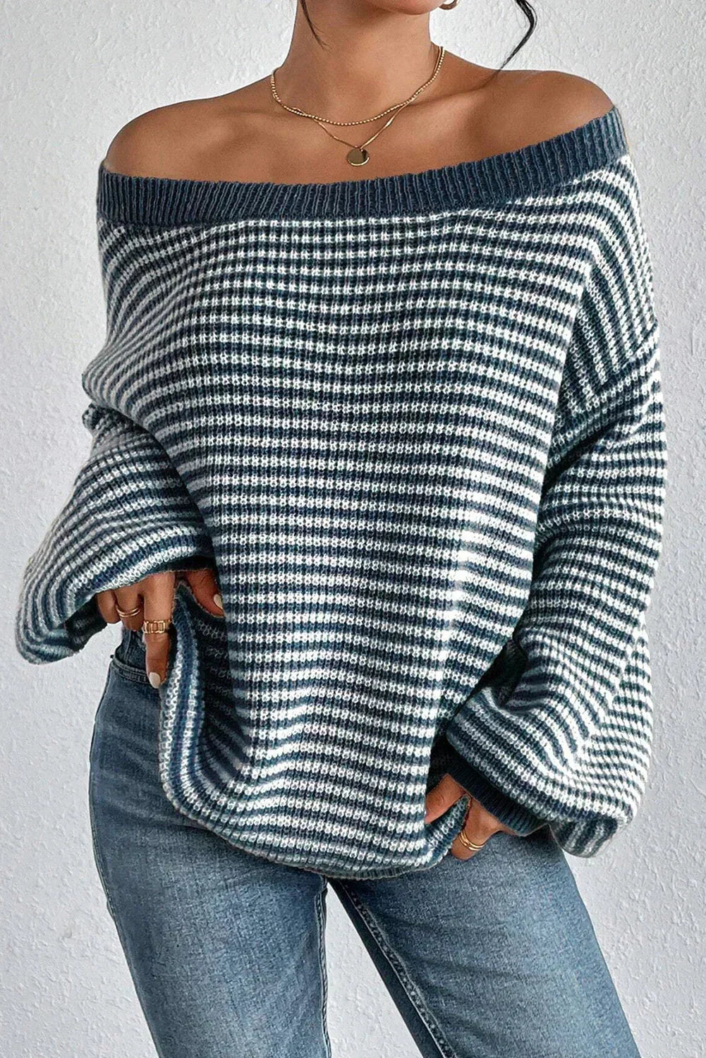 Striped off-shoulder knit sweater with dropped shoulder shown on a model