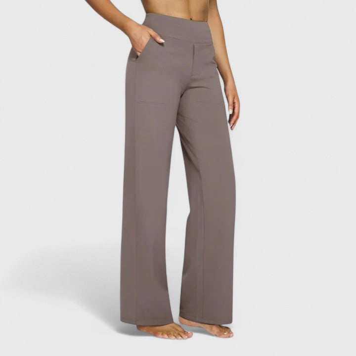 Model wearing wide-waistband trousers with a relaxed wide-leg cut