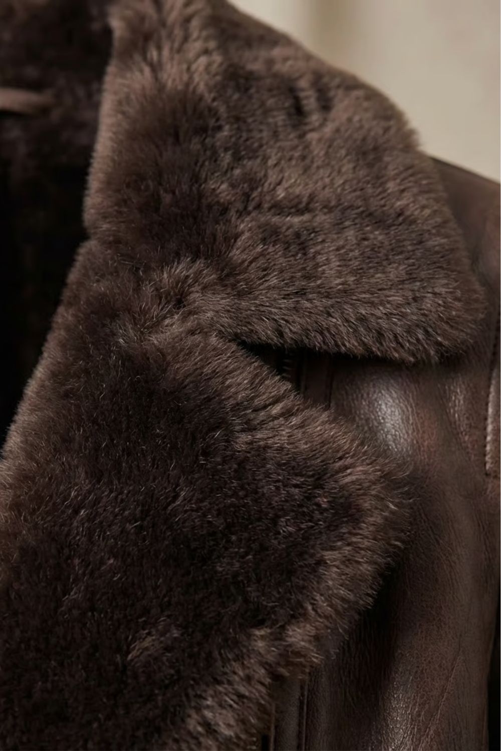 Full-length view of brown faux leather shearling-collar jacket on model