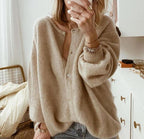 Oversized taupe knit cardigan with button-front styling on model