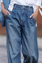 Blue pleated wide-leg jeans, close-up detail
