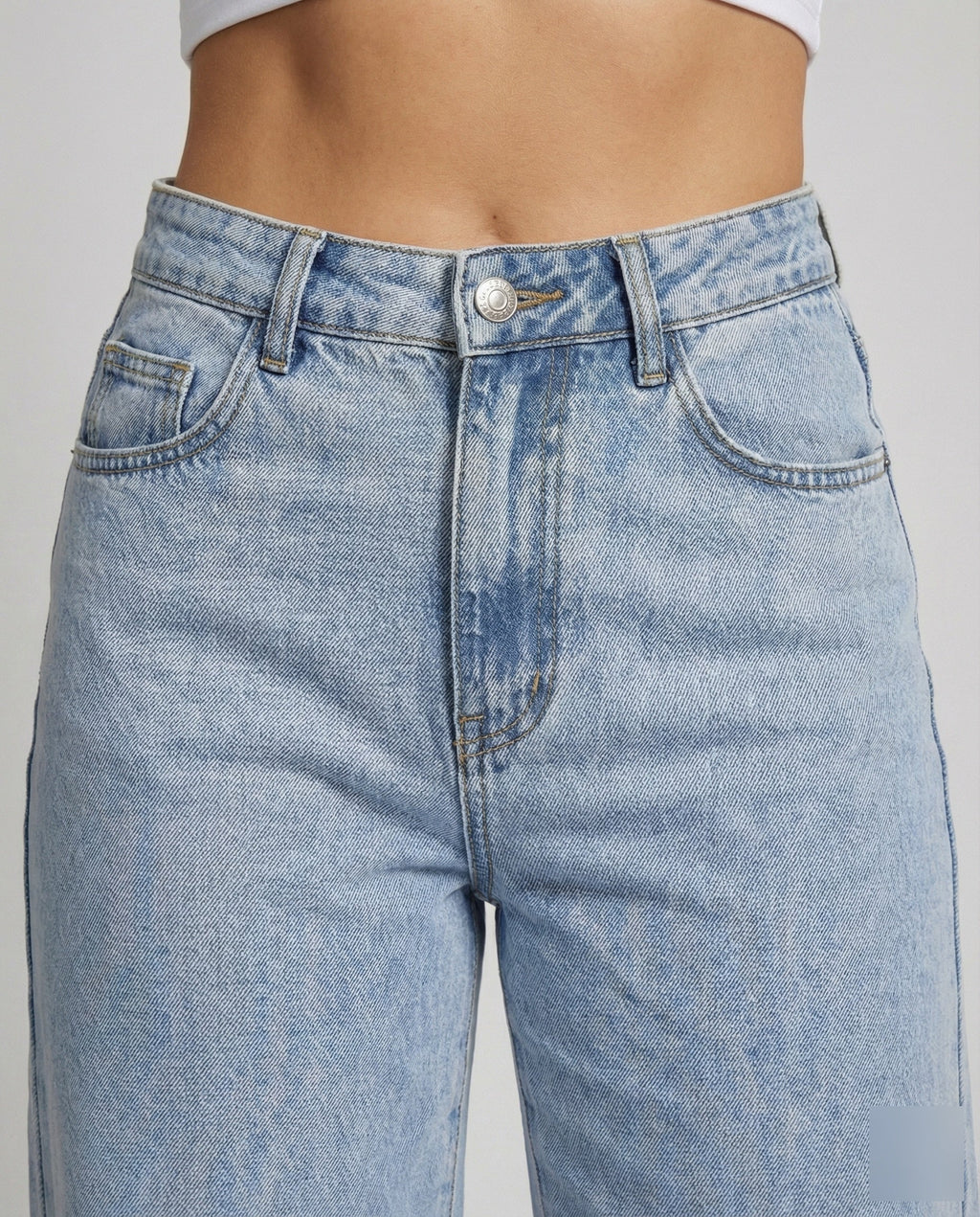 Close-up detail of soft-touch denim wide-leg jeans
