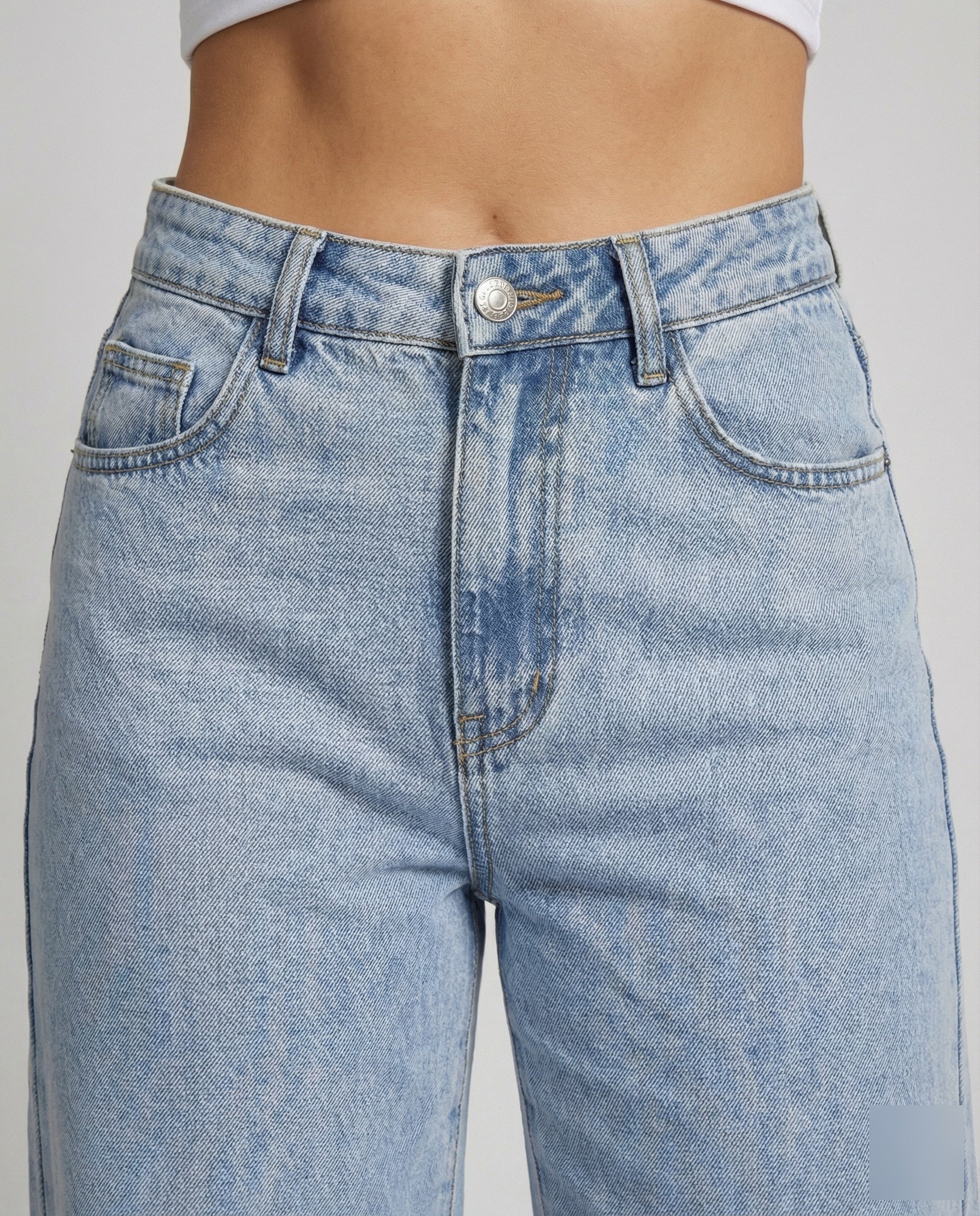 Close-up detail of soft-touch denim wide-leg jeans