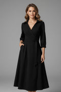 Wrap-front midi dress showing defined waist and drape