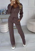 Woman wearing a zip-front tracksuit with drawstring waist, front view